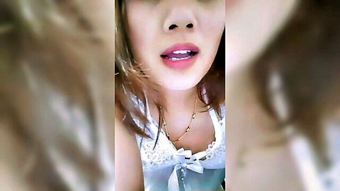 Sexy Thai babe teases with open mouth and cleavage in lacy blue top selfie