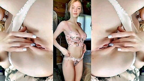 Redhead beauty in pink floral lingerie posing seductively