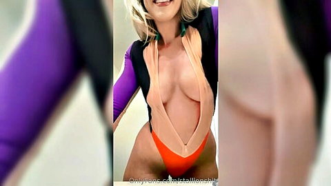 Blonde babe in revealing purple swimsuit with deep cleavage selfie