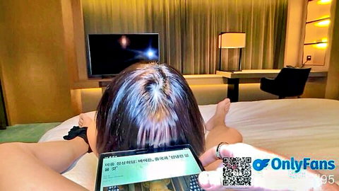 Nude Asian woman lying on bed, legs spread, promoting OnlyFans