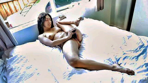 Shy Asian woman nude on bed, fingering herself seductively