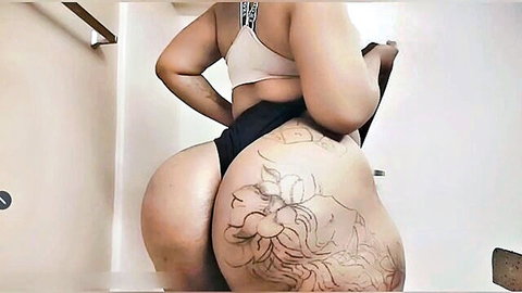 Ebony BBW babe bends over showing massive tattooed ass in tight black thong