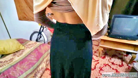 Algerian Arab woman in crop top and skirt, seductive back view