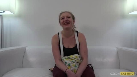 Nikole smiling on couch at Czech Casting audition