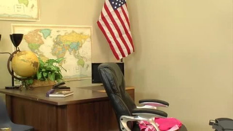 Riley Reid in office chair with black leather desk setup