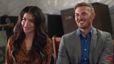 Gal Ritchie in leopard print top with smiling suited man