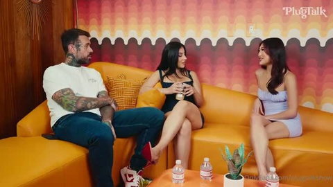 Lena The Plug and Mina Luxx on couch with tattooed man