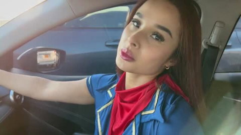 Colombian stewardess in uniform selfie in car