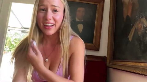 Briar Riley in pink lingerie smiling at camera
