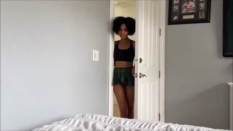 Addis Fouche in plaid skirt peeking through doorway, Family Therapy scene