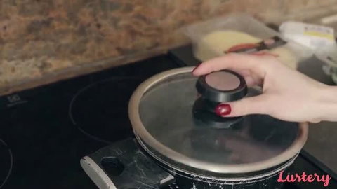 Arden gripping pot lid on stove in kitchen setting, Lustery amateur video