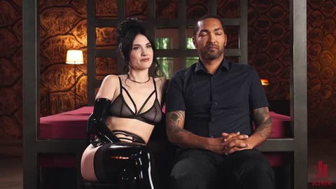 Reese the Ram in black latex lingerie with Mickey Mod in BDSM scene