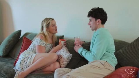 Charlie Forde and Nick Strokes relaxing on couch in casual home clothing