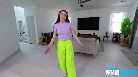 Stella Nash in purple crop top and neon green pants
