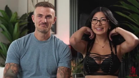 Cami Strella smiling in black strappy lingerie and glasses