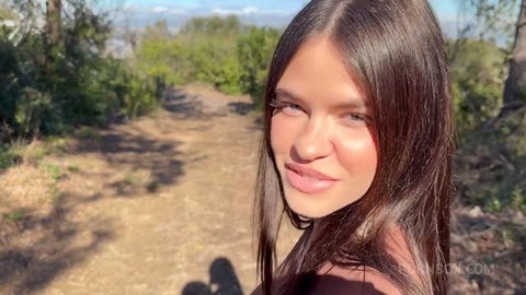 Rossa Vaxx selfie on mountain trail, long brown hair, outdoors