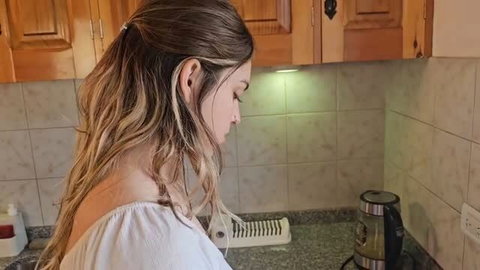 Keila Bassi side profile in white top, long highlighted hair