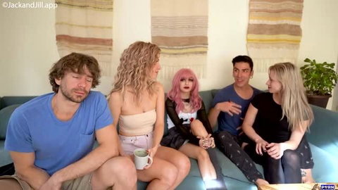 Group of five adults chatting on couch in casual clothing