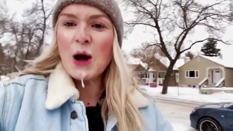 Blonde woman with cum on chin in snowy Canadian outdoor scene