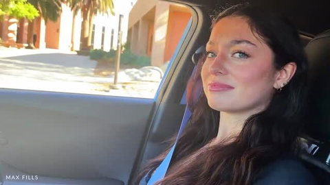 Violet Ray in car selfie with long dark hair and blue eyes