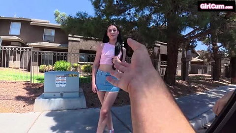 Dolly Paige in pink crop top and denim skirt on sunny outdoor set