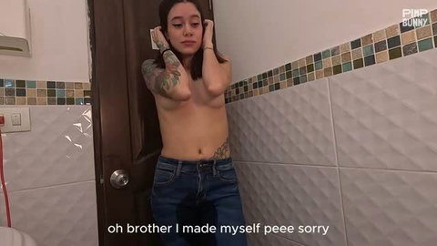 Minami topless in bathroom, hands behind head, jeans on, tattooed slim body