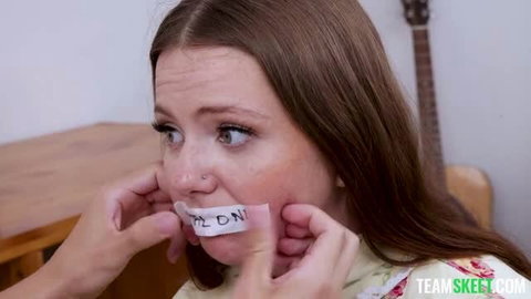 Lily Thot with duct tape over mouth in Team Skeet teen scene