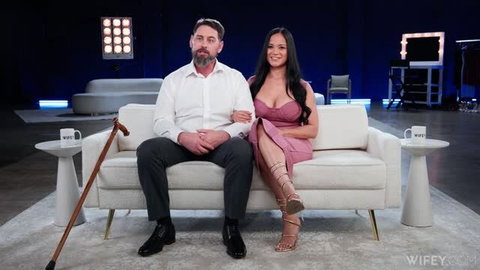 Jazmine Cruz hotwife couple interview couch, white shirt black dress