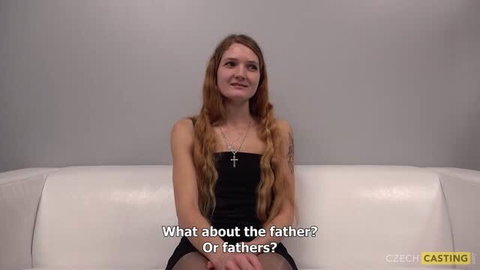 Lenka from Czech Casting on white couch in black dress
