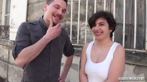 Anastasia smiling in white tank top with male costar, amateur orgy thumbnail