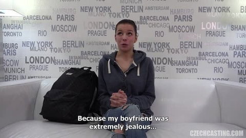 Linda on Czech Casting audition couch, wearing jeans and hoodie