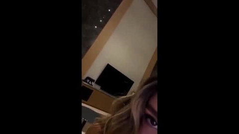 Lyna Perez closeup selfie in dimly lit room, blonde hair