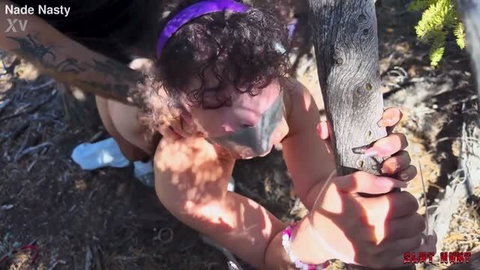 Pixie Smalls outdoors getting pissed on during slut hunt punishment scene