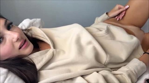 Sophie Tyler in oversized hoodie teasing with stockings on bed