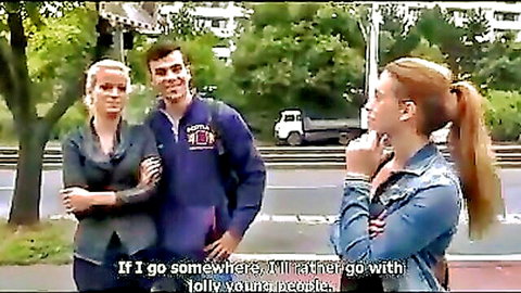 Two clothed blondes chatting with curly-haired guy outdoors on street preferring younger people