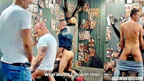 Muscular men in kinky brothel, one nude butt exposed, group setup