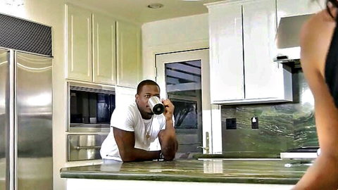 Black stud smirks at curvy brunette's big ass while sipping coffee in kitchen