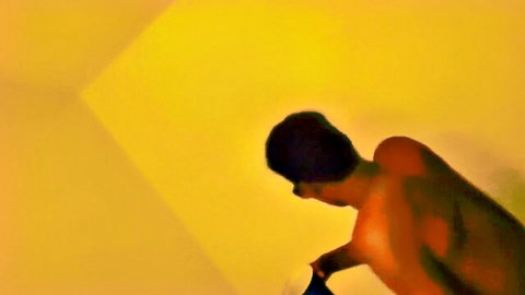 Muscular ebony man bending over shirtless in yellow room homemade tease