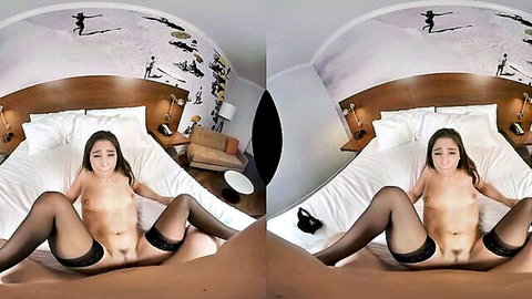 Young brunette in black stockings spreads legs wide exposing shaved pussy on bed POV VR