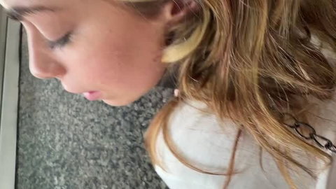Renee Rose side profile closeup with blonde hair and ear piercings