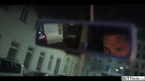 Catherine Knight in car rearview mirror, close-up face at night