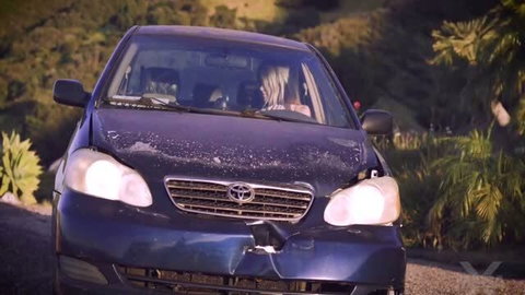 Nicole Nichols in damaged car, face visible behind windshield