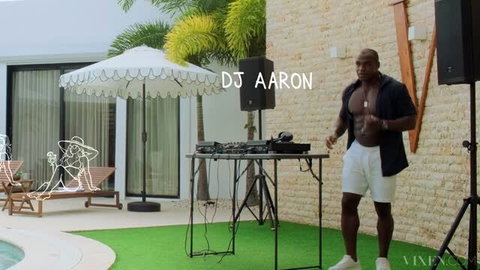 DJ Aaron shirtless mixing music at luxury poolside party