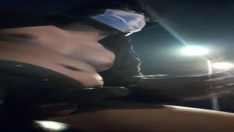 Nude woman driving at night, steering wheel view