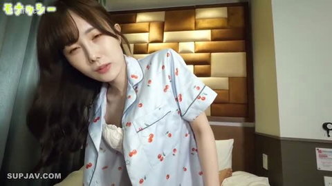 Japanese AV model in cherry print pajamas, long dark hair, softcore bedroom tease