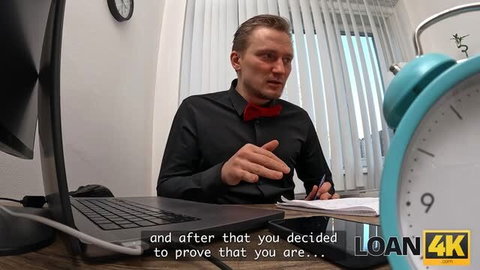 Office loan scene with suited man holding pen at desk