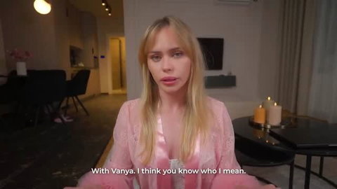 Blonde woman in sheer pink lingerie sitting at table, softcore adult scene