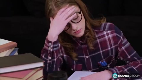 Melody Marks studying in plaid shirt and glasses
