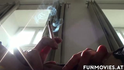 Brunette babe smokes cigarette with sunlight flare in window