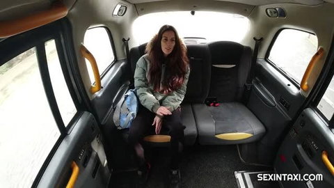 Ali Bordeaux in taxi, long dark hair, green jacket, black leggings